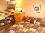 Main level bedroom 2 with queen bed, twin bunks